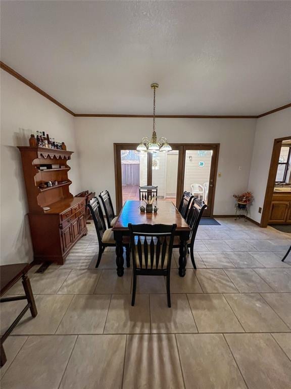 dining space with baseboards, an inviting chandelier, and crown molding