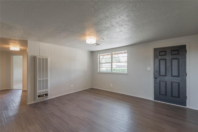 unfurnished room featuring dark hardwood / wood-style floors and a textured ceiling