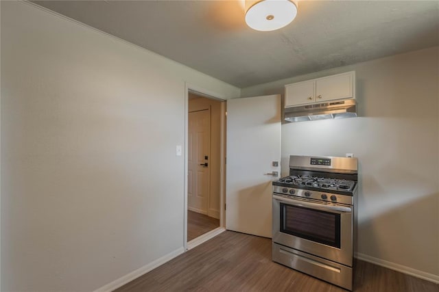 kitchen with dark hardwood / wood-style flooring, gas range, and white cabinets