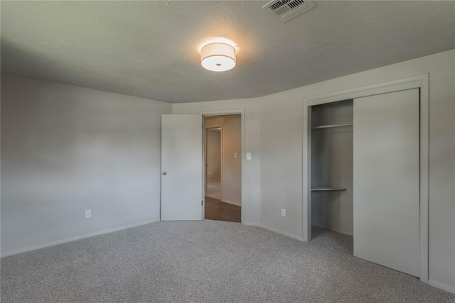 unfurnished bedroom with carpet and a closet