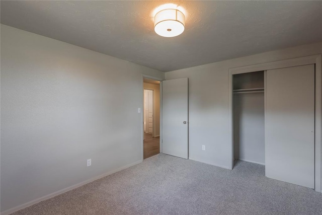 unfurnished bedroom featuring carpet and a closet