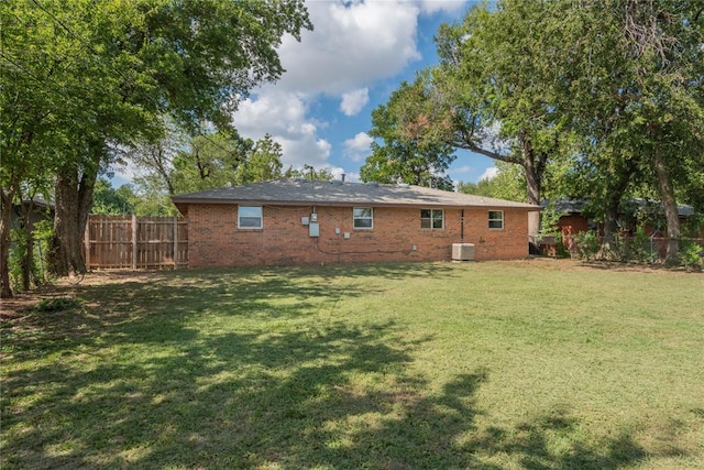 back of property featuring a yard