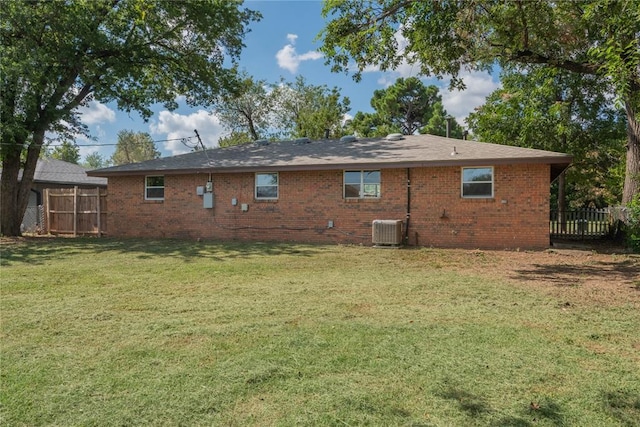 back of house with a lawn and central air condition unit