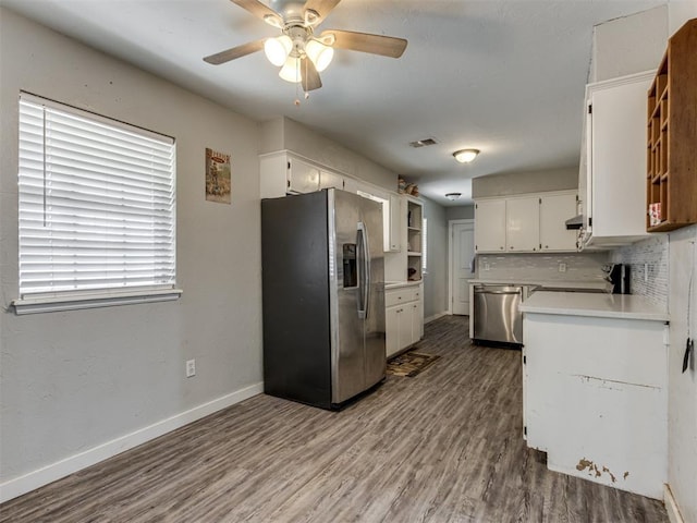 kitchen featuring white cabinets, appliances with stainless steel finishes, dark wood-type flooring, tasteful backsplash, and ceiling fan