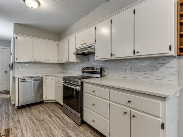 kitchen featuring light hardwood / wood-style flooring, decorative backsplash, stainless steel appliances, and white cabinetry