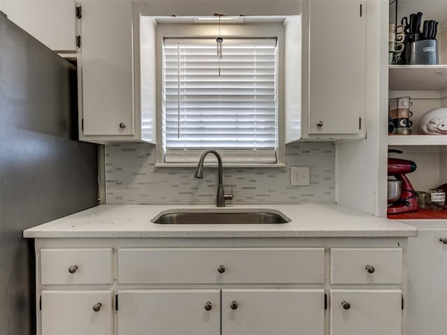 kitchen featuring sink and white cabinetry