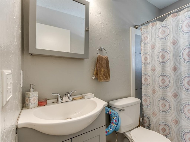 bathroom featuring toilet and vanity