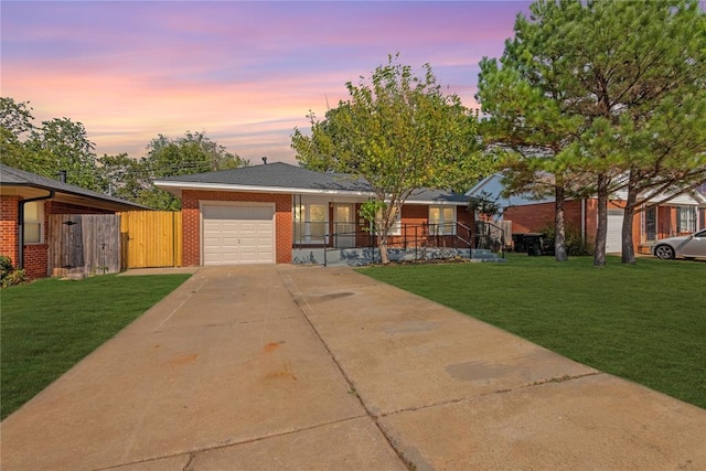 view of front of home featuring a garage and a lawn