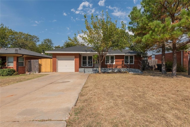 ranch-style home featuring a front yard, a carport, covered porch, and a garage