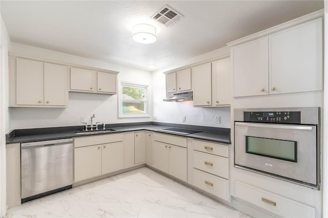 kitchen featuring sink, stainless steel appliances, and cream cabinets