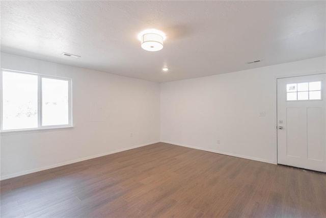 empty room featuring dark hardwood / wood-style flooring