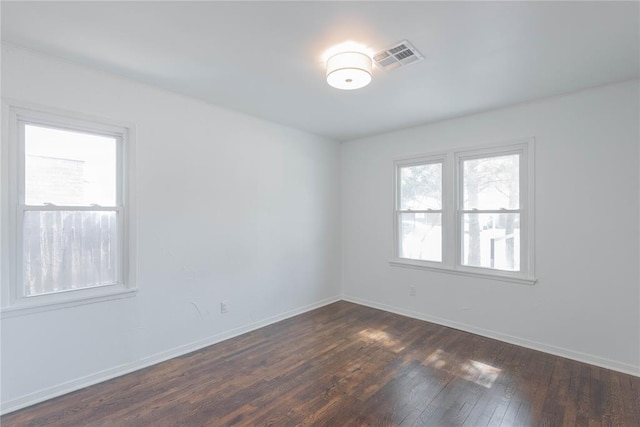 empty room featuring dark wood-type flooring