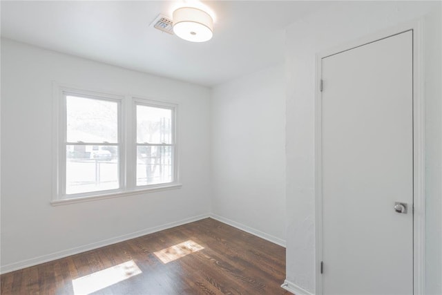 spare room with dark hardwood / wood-style flooring