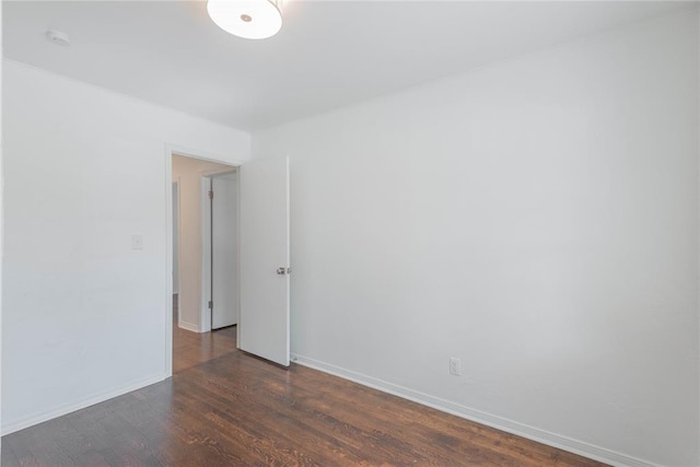 unfurnished room featuring dark hardwood / wood-style flooring