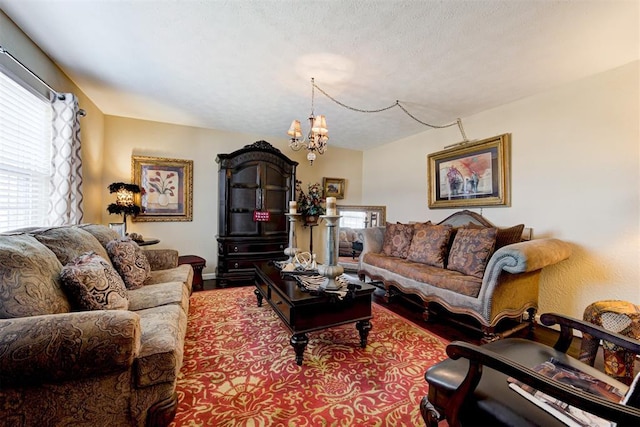 living room featuring a textured ceiling and a notable chandelier