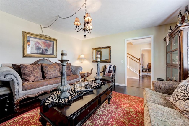 living room with dark wood-type flooring and a chandelier