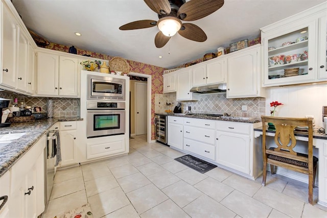 kitchen with wine cooler, white cabinets, dark stone counters, and stainless steel appliances