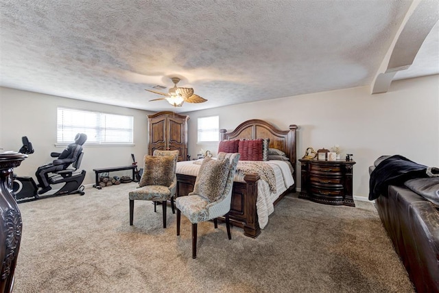 bedroom with ceiling fan, a textured ceiling, and carpet floors