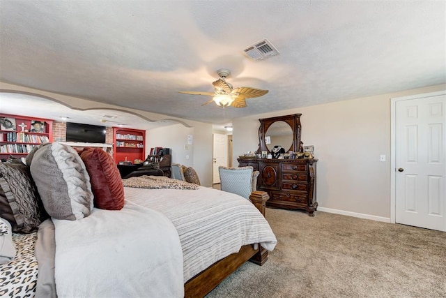 carpeted bedroom with ceiling fan and a textured ceiling