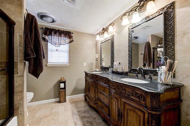 bathroom featuring a textured ceiling, toilet, vanity, and tile patterned flooring