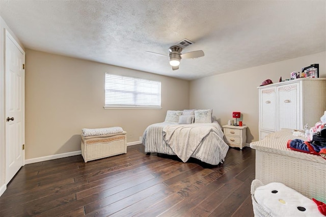 bedroom featuring ceiling fan, dark hardwood / wood-style flooring, and a textured ceiling