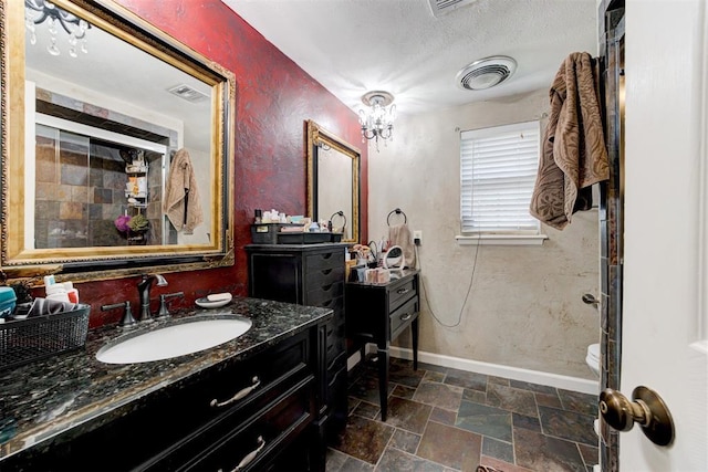 bathroom featuring toilet, a shower, and vanity