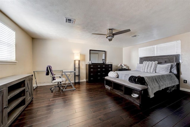 bedroom featuring ceiling fan, a textured ceiling, and dark hardwood / wood-style flooring