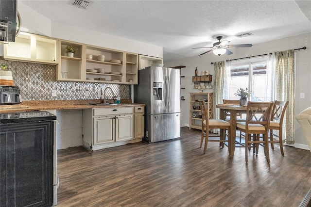 kitchen with dark wood-type flooring, sink, a textured ceiling, appliances with stainless steel finishes, and ceiling fan