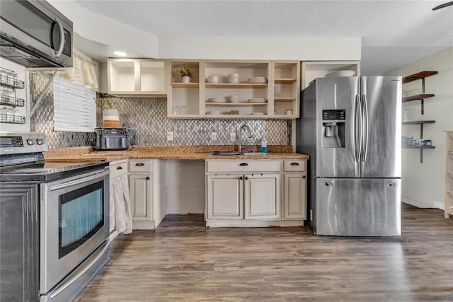 kitchen featuring dark hardwood / wood-style flooring, sink, a textured ceiling, and appliances with stainless steel finishes