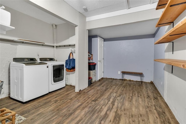 washroom featuring washer and dryer, a textured ceiling, and dark hardwood / wood-style flooring