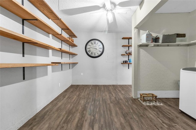 interior space with ceiling fan, dark hardwood / wood-style floors, and washer / dryer