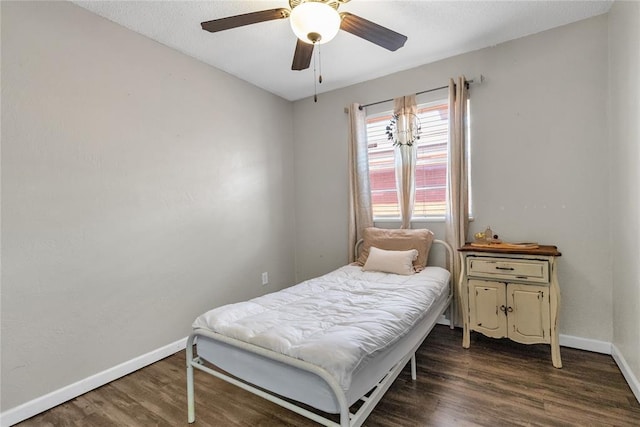 bedroom featuring dark hardwood / wood-style floors and ceiling fan