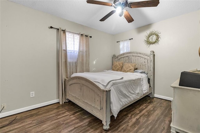 bedroom featuring ceiling fan, dark hardwood / wood-style floors, and a textured ceiling