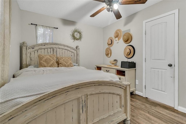 bedroom with wood-type flooring and ceiling fan