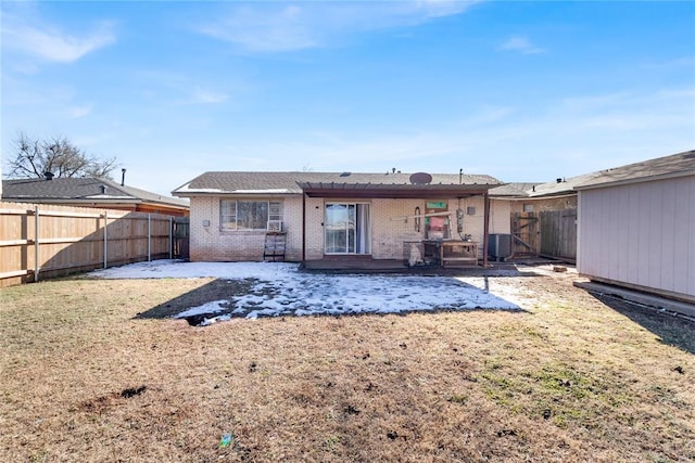 rear view of house with a patio, central AC, and a lawn