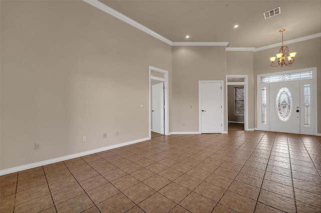 tiled foyer featuring crown molding and a chandelier