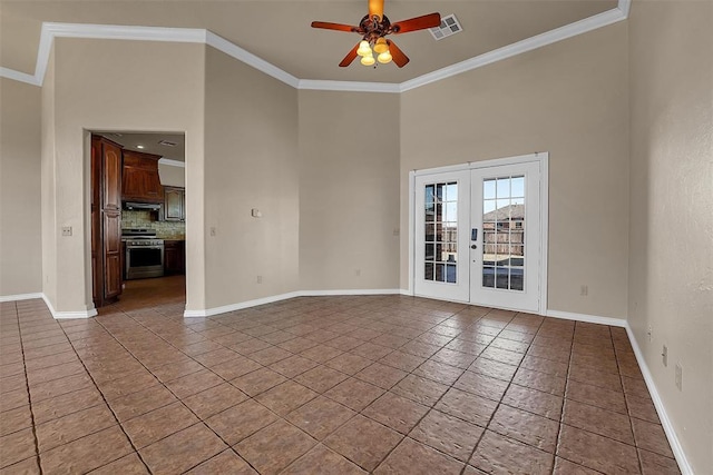 spare room with ceiling fan, crown molding, and french doors