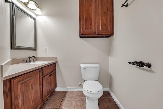 bathroom featuring toilet, tile patterned floors, and vanity