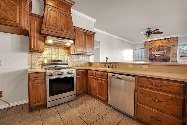 kitchen featuring ceiling fan, sink, crown molding, appliances with stainless steel finishes, and light tile patterned floors