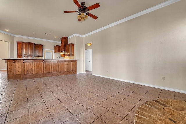 kitchen featuring kitchen peninsula, ceiling fan, a breakfast bar area, light tile patterned flooring, and ornamental molding