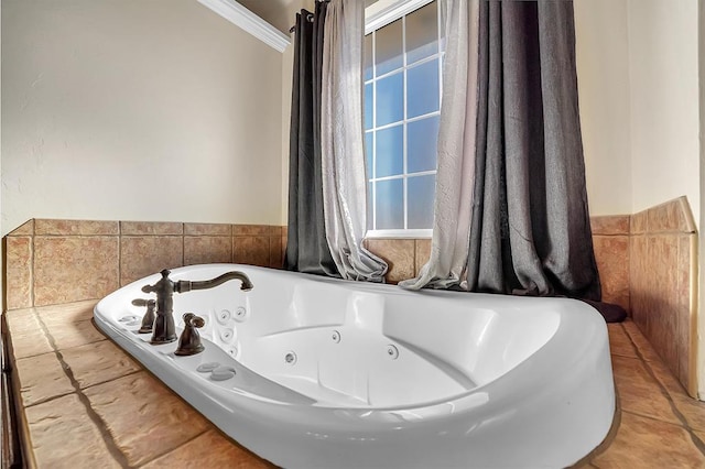 bathroom with a bath and crown molding