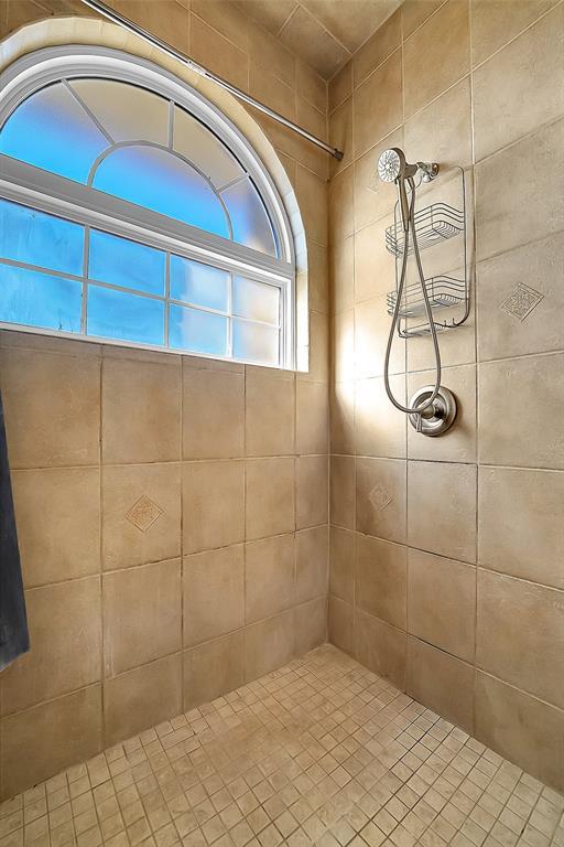 bathroom with tiled shower