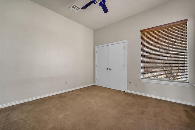 unfurnished bedroom featuring ceiling fan, carpet, and lofted ceiling