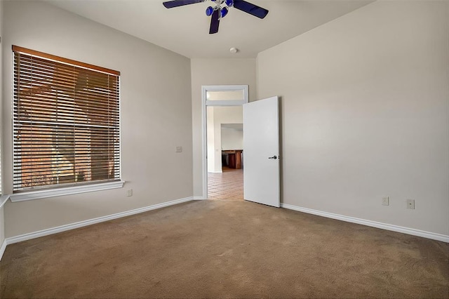 spare room featuring ceiling fan and carpet