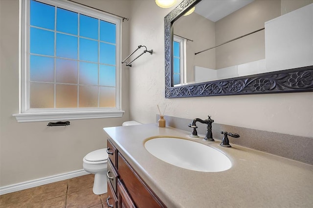 bathroom featuring toilet, vanity, and tile patterned flooring