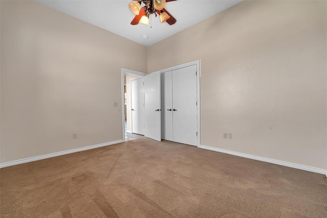 unfurnished bedroom featuring ceiling fan and light carpet