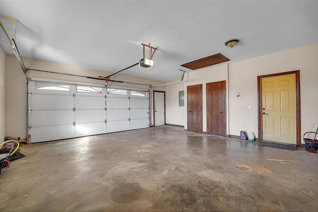 garage with electric panel and a garage door opener