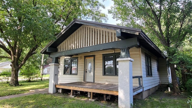 rear view of property with a yard