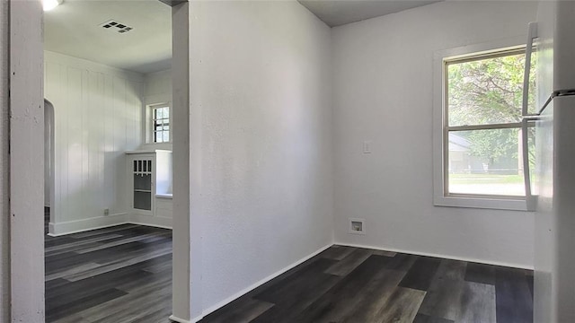 unfurnished room with dark hardwood / wood-style floors