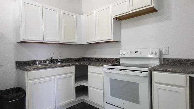 kitchen with sink, white cabinetry, and white electric range oven